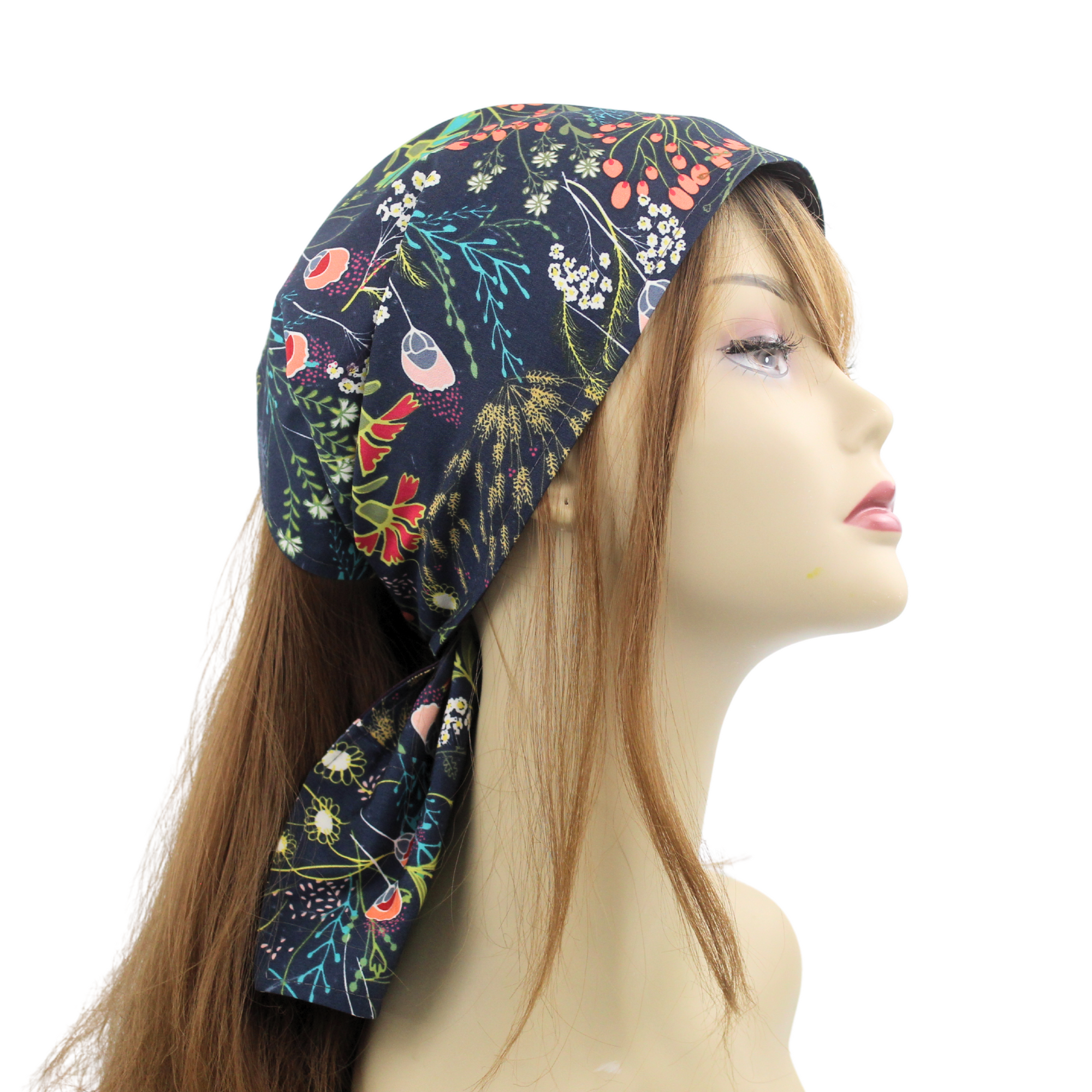 A mannequin head wearing a dark blue satin lined expandable headscarf with a floral pattern and ties.