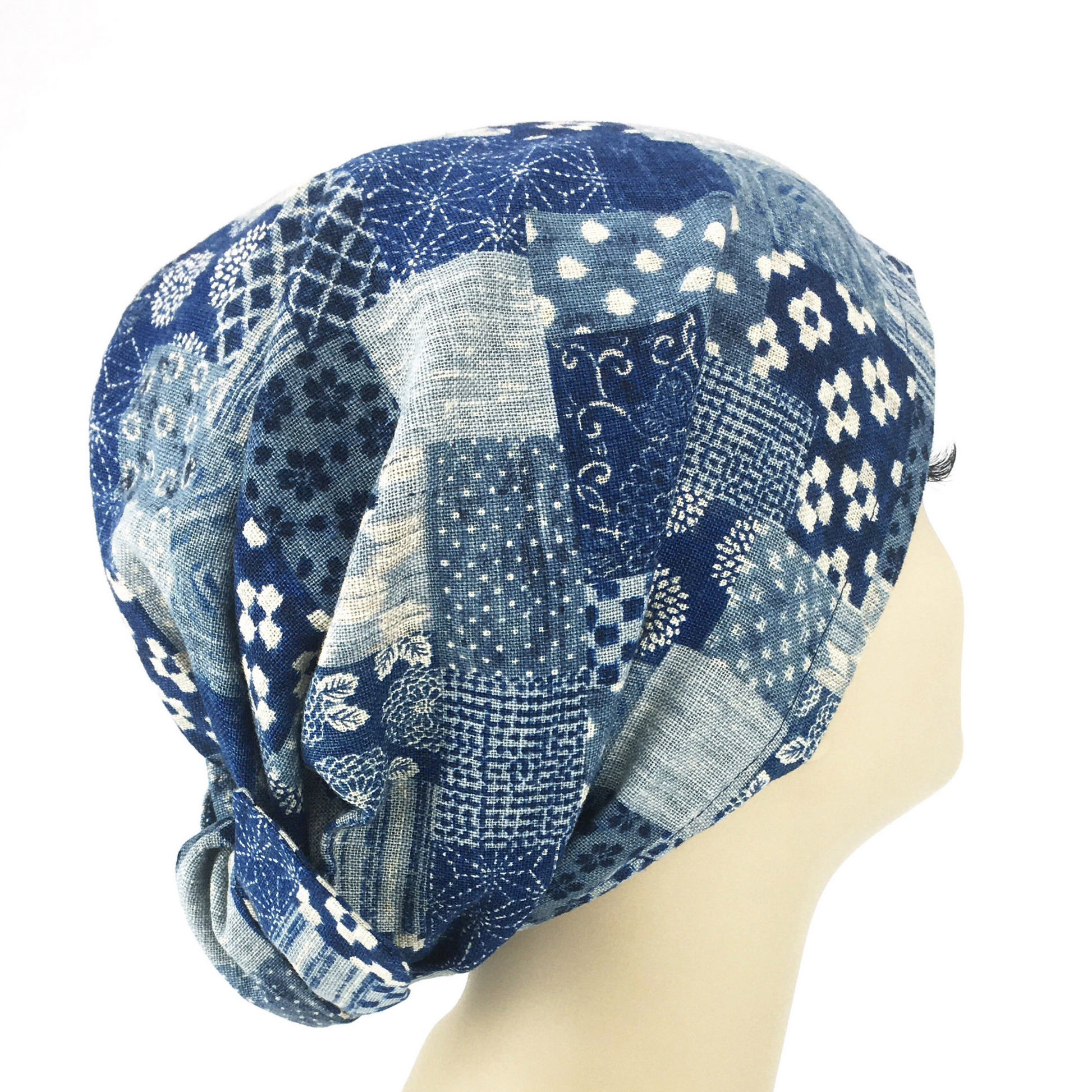 Blue patterned headscarf on a mannequin head against a white background