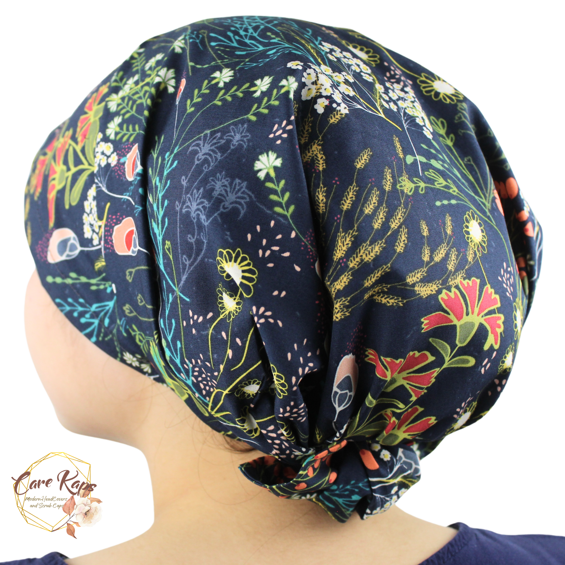 Floral patterned headscarf on a person with 'Care Caps' logo.