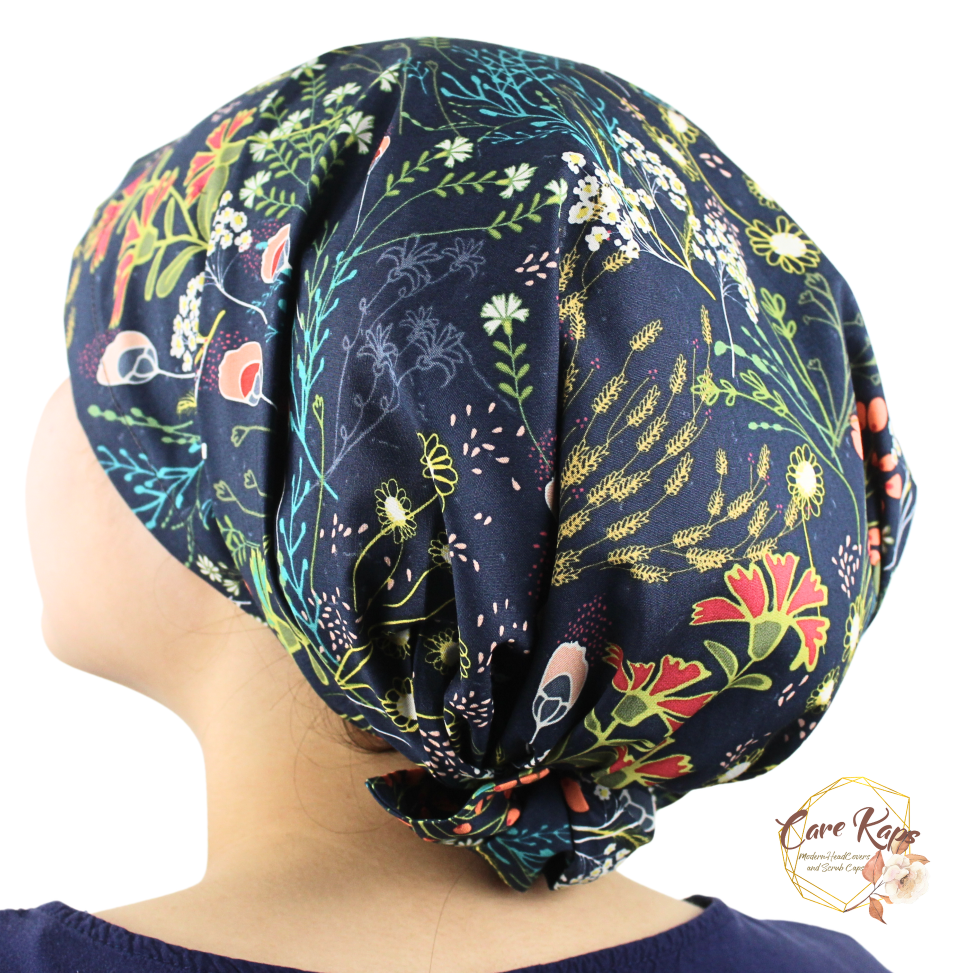 Navy blue headscarf with colorful floral pattern worn by a person on a white background