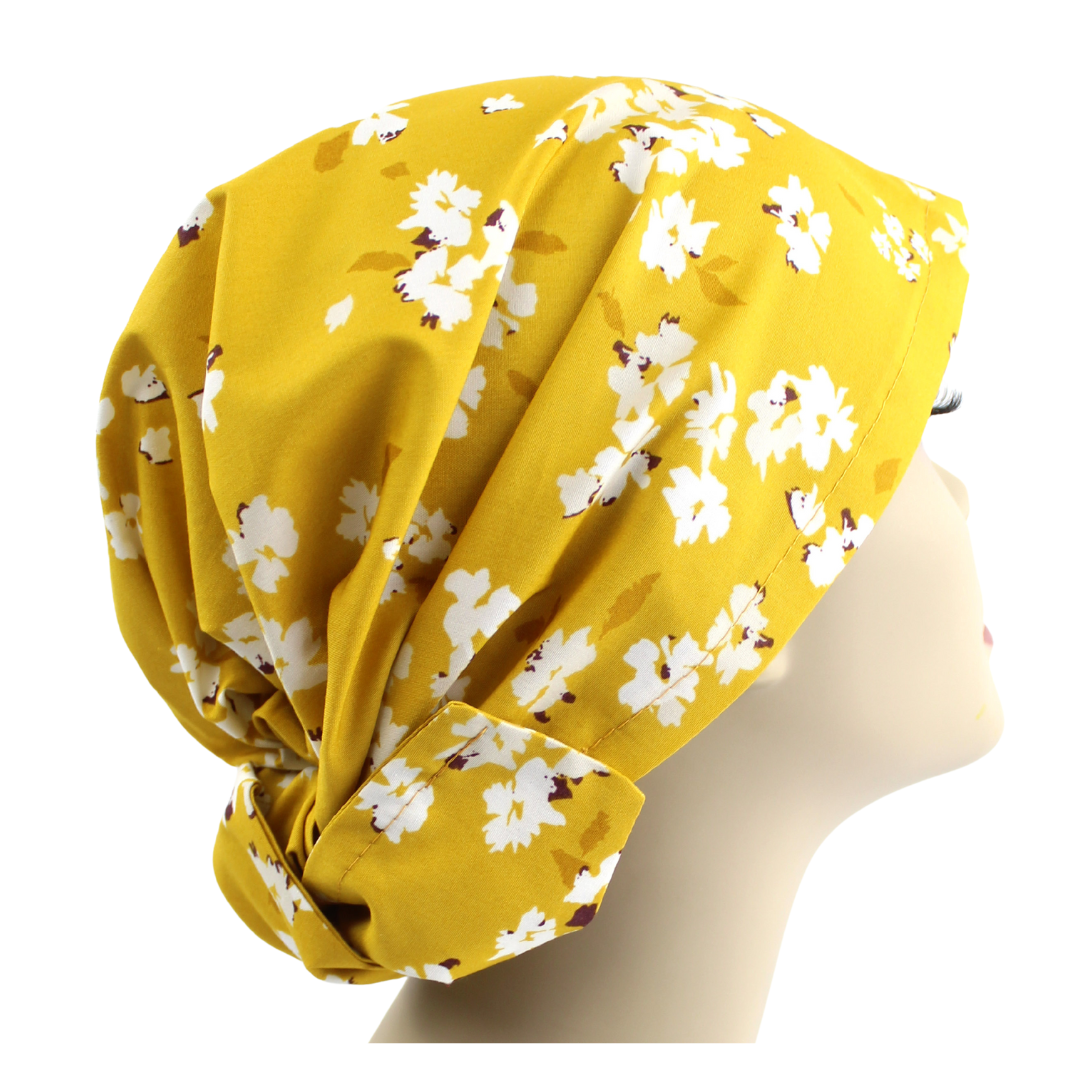 A yellow floral hair wrap on a mannequin head.