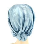 Light blue headscarf on a mannequin head against a white background