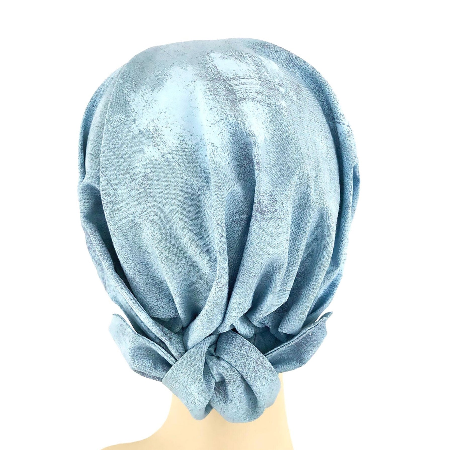 Light blue headscarf on a mannequin head against a white background