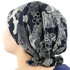 Navy blue and white floral patterned headscarf on a person against a white background