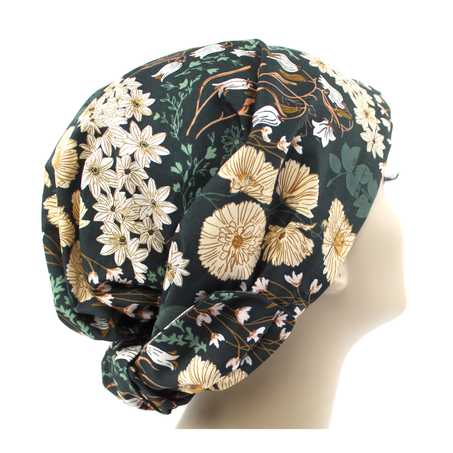 A dark green floral hair wrap with large fabric ties, displayed on a mannequin head.